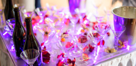 Champagne glasses. Wedding slide champagne for bride and groom outdoors. Colorful wedding glasses with champagne. Catering service. Catering bar for celebration. Beauty of bridal interior for wedding